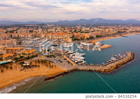 Aerial view of French town of Frejus on Mediterranean coast overlooking marina Aerial view of French town of Frejus on Mediterranean coast overlooking marina 84310254