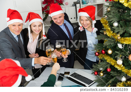 Happy business group people in santa hat at Xmas corporate party Happy business group people in santa hat at Xmas corporate party 84310289