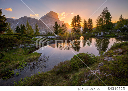 sunrise over pond close to Lago di Limides, Dolomites, Italy 84310325