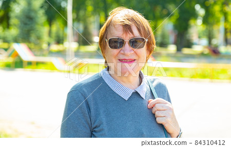 Portrait of a smiling mature woman Portrait of a smiling mature woman 84310412