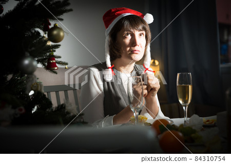 Girl is bored alone in New Year night Girl is bored alone in New Year night 84310754