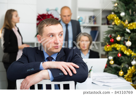 Frustrated man sitting at office 84310769