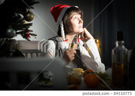 Bored woman watching Christmas tv program 84310773