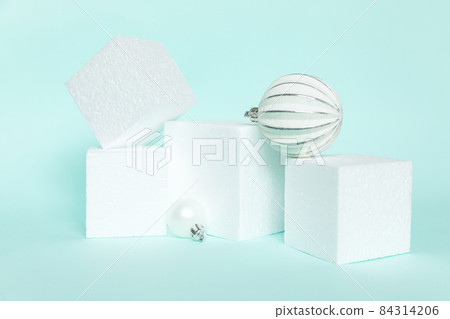 Simply minimal composition winter objects ornament and cube shapes geometric form podium isolated blue pastel background. Christmas New Year december time for celebration concept. Mockup copy space Simply minimal composition winter objects ornament and cube shapes geometric form podium isolated blue pastel background. Christmas New Year december time for celebration concept. Mockup copy space 84314206