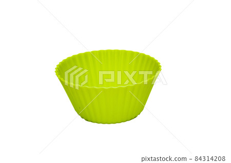 Green silicone cupcake baking dish isolated on white background Green silicone cupcake baking dish isolated on white background 84314208