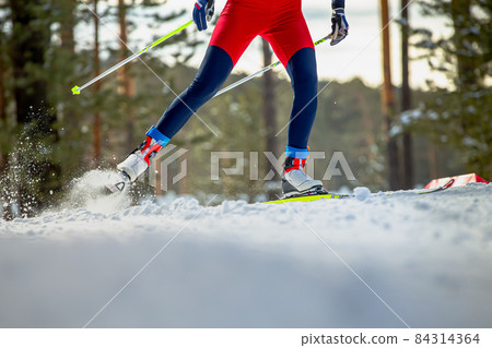 male skier athlete goes uphill on cross-country skiing 84314364