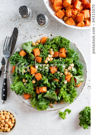 Healthy vegan salad with roasted sweet potato and kale cabbage 84315070