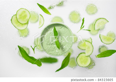 Handmade organic bio nature cosmetics with cucumber ingredients on gray background. Natural beauty and spa concept. Space for text 84315605
