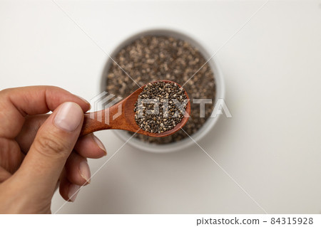 Chia seeds in wooden spoon and cup from top view with space on white background with copy space, view from above Chia seeds in wooden spoon and cup from top view with space on white background with copy space, view from above 84315928