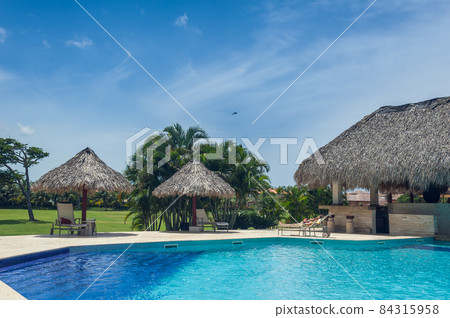 Outdoor resort Swimming pool of luxury hotel in summer spa near the sea. Tropical Paradise. Dominican Republic, Seychelles, Caribbean, Bahamas. 84315958