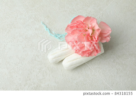 Tampons and flower on white textured background 84318155