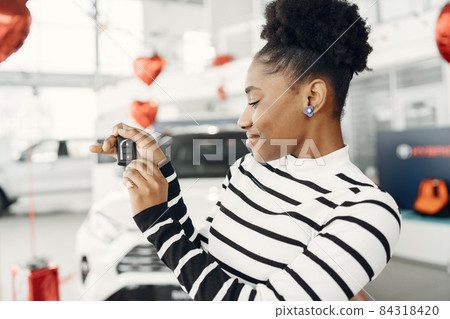 Young african american woman in car salon Young african american woman in car salon 84318420