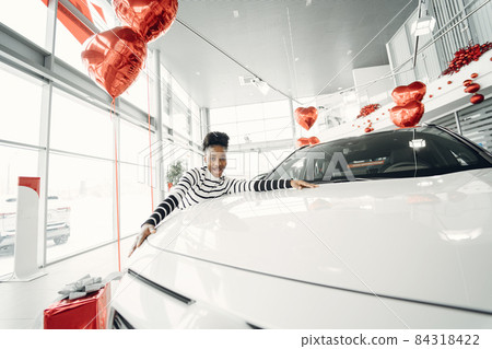Young african american woman in car salon Young african american woman in car salon 84318422