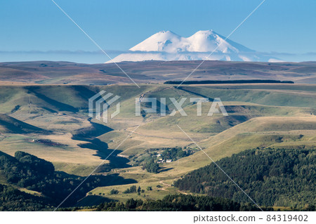 Mountain Elbrus with snowy peaks beautiful nature landscape, View at long distance. Mountain Elbrus with snowy peaks beautiful nature landscape, View at long distance. 84319402