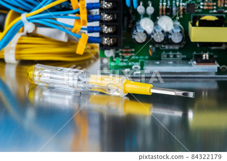 Electrical repair shop, tool and equipment on metal workshop table close-up 84322179