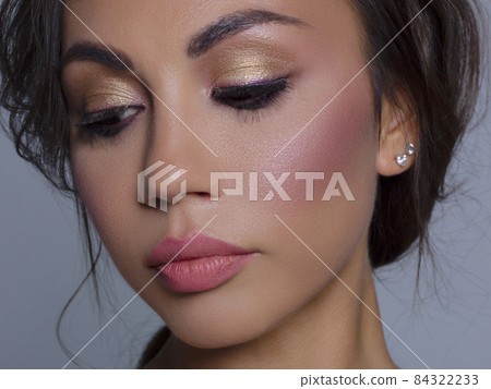 Beautiful brunet model woman face with brown eyes and perfect make-up . Portrait of beauty young brunet girl with pink lips. Female face with clear skin close-up. Skincare Beautiful brunet model woman face with brown eyes and perfect make-up . Portrait of beauty young brunet girl with pink lips. Female face with clear skin close-up. Skincare 84322233