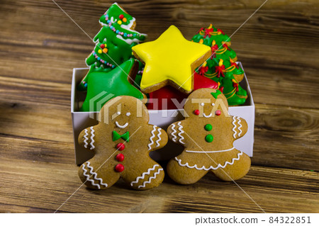 Tasty Christmas gingerbread cookies in box on wooden table 84322851