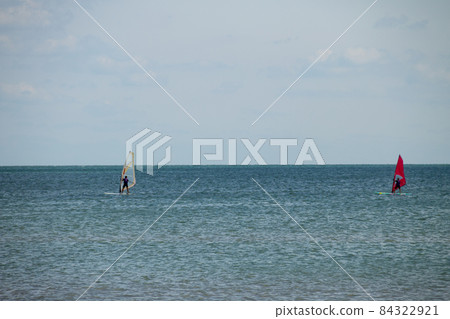 Windsurfing. Surfer exercising in calm sea or ocean. 84322921