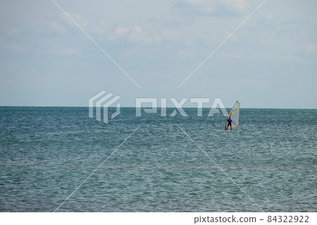 Windsurfing. Surfer exercising in calm sea or ocean. 84322922