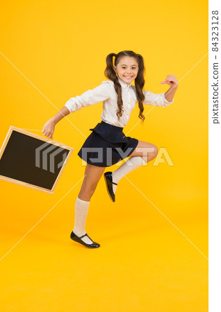 Starting school with a smile. Happy small child going Starting school with a smile. Happy small child going 84323128