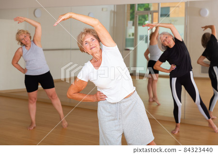 Mature women practice active dancing in the studio Mature women practice active dancing in the studio 84323440