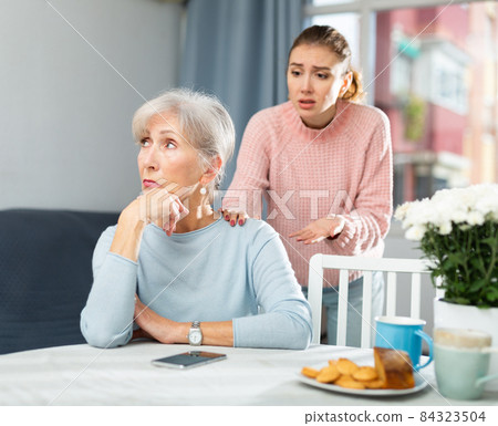 Offended elderly woman listening her daughter swearing 84323504