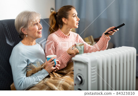 Grandmother and granddaughter watching TV 84323810