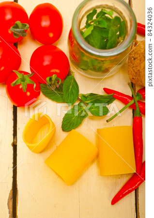 Italian pasta paccheri with tomato mint and chili pepper 84324036