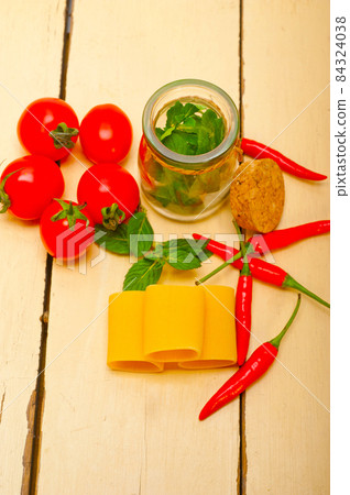 Italian pasta paccheri with tomato mint and chili pepper 84324038