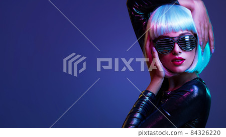 Stylish blonde in shiny dress and sunglasses with stresses. Closeup face of beautiful fashionable woman in white wig. Art portrait of an young attractive model. Fantasy style. Glamour fashion girl Stylish blonde in shiny dress and sunglasses with stresses. Closeup face of beautiful fashionable woman in white wig. Art portrait of an young attractive model. Fantasy style. Glamour fashion girl 84326220