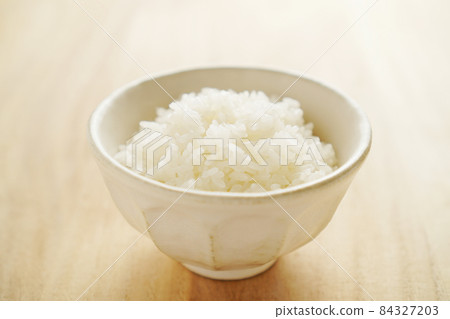 Rice served in a bowl Rice served in a bowl 84327203