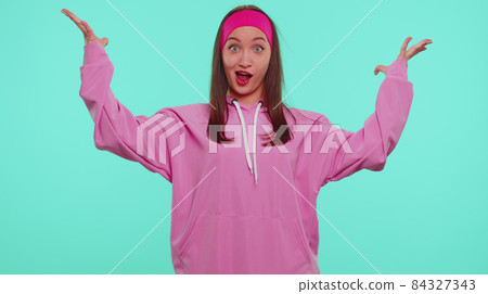 Excited amazed girl looking shocked surprised wow showing hands brain explosion head gesture, wow 84327343