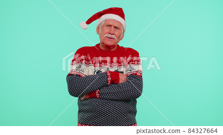 Upset angry man in Christmas deer antlers raising hands in indignant expression, quarreling conflict Upset angry man in Christmas deer antlers raising hands in indignant expression, quarreling conflict 84327664