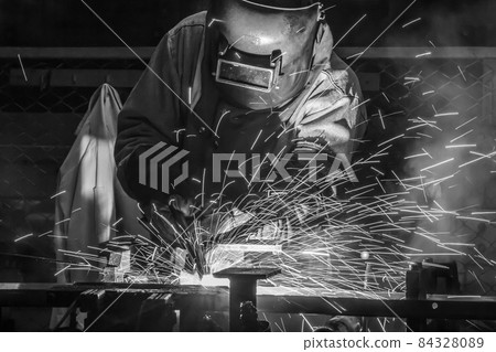 worker with protective mask welding metal 84328089