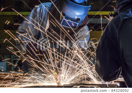 worker with protective mask welding metal 84328092