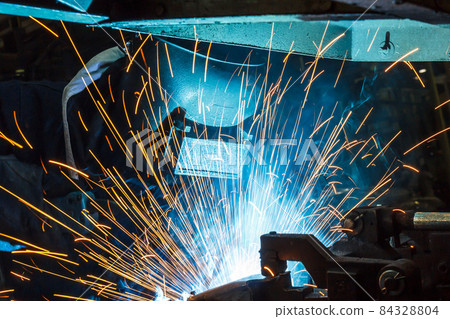 worker with protective mask welding metal 84328804