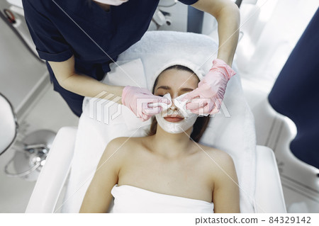 Woman in cosmetology studio on a procedures 84329142
