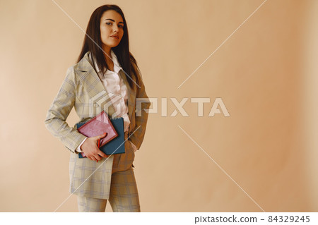 Woman standing on a brown background 84329245