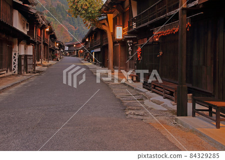 Tsumago-juku at twilight in autumn, an important traditional building preservation district of the country 84329285