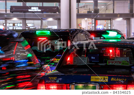 A line of taxis waiting for passengers in front of Nagoya Station at night A line of taxis waiting for passengers in front of Nagoya Station at night 84334025