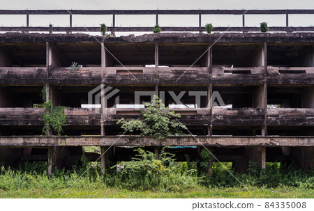 External of old abandoned building and was left to deteriorate over time and visible parts of structural elements and ruins. External of old abandoned building and was left to deteriorate over time and visible parts of structural elements and ruins. 84335008