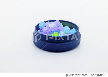 Lots of konpeito in a container 84336053