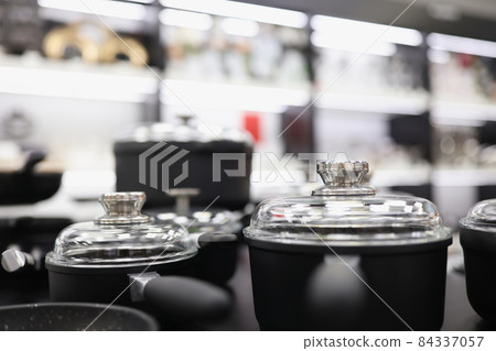 Set of pots and pans with lids in kitchen Set of pots and pans with lids in kitchen 84337057