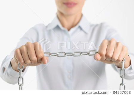 Businessman firmly holds chrome chain in hands 84337068