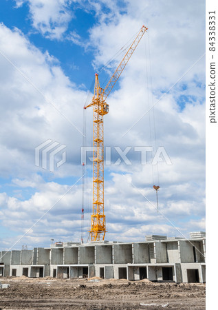 Tall cranes and building of houses 84338331