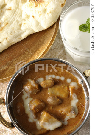 Massaman curry, naan and lassie with lots of ingredients such as chicken and peanuts Massaman curry, naan and lassie with lots of ingredients such as chicken and peanuts 84338797