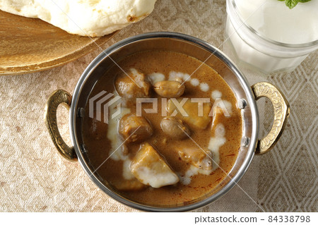 Massaman curry, naan and lassie with lots of ingredients such as chicken and peanuts Massaman curry, naan and lassie with lots of ingredients such as chicken and peanuts 84338798