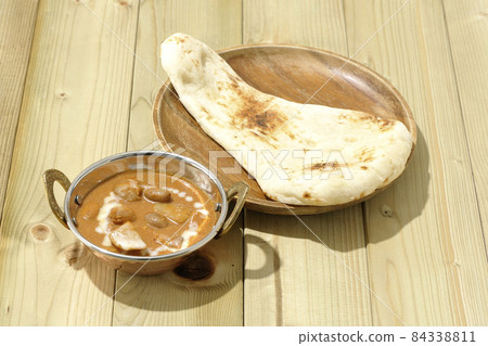 Massaman curry and naan with lots of ingredients such as chicken and peanuts Massaman curry and naan with lots of ingredients such as chicken and peanuts 84338811
