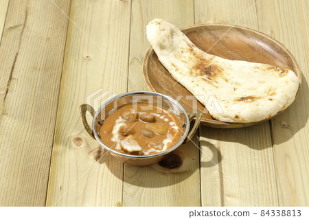 Massaman curry and naan with lots of ingredients such as chicken and peanuts Massaman curry and naan with lots of ingredients such as chicken and peanuts 84338813