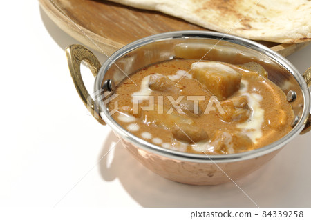 Massaman curry and naan with lots of ingredients such as chicken and peanuts taken on a white background 84339258